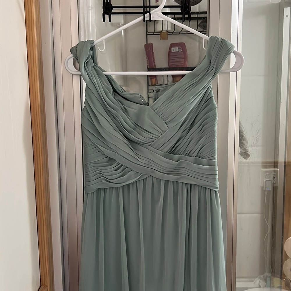 size six sage green floor length bridesmaids dress that has a slit on the side.